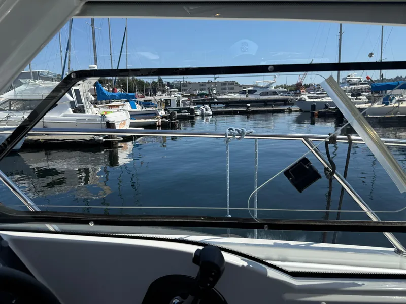Slide: The Image of View from 2021 Beneteau Antares 8, overlooking marina with boats and clear blue sky. - 17