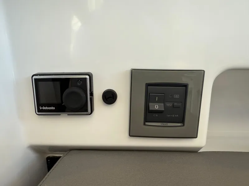 Slide: The Image of Control panel on 2021 Beneteau Antares 8 boat featuring Webasto and Vimar switches. - 18