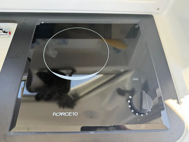 Slide: The Image of Force 10 stove on 2021 Beneteau Antares 8 boat, featuring a sleek black design. - 20