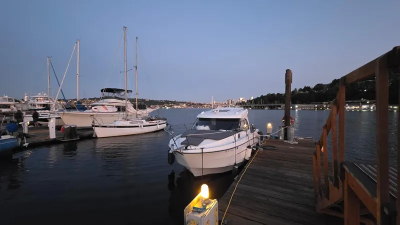 Slide: The Image of 2021 Beneteau Antares 8 docked at a marina during twilight. - 3