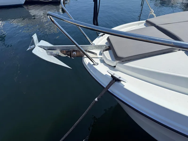 Slide: The Image of Bow of 2021 Beneteau Antares 8 with anchor and railing, docked on calm water. - 33