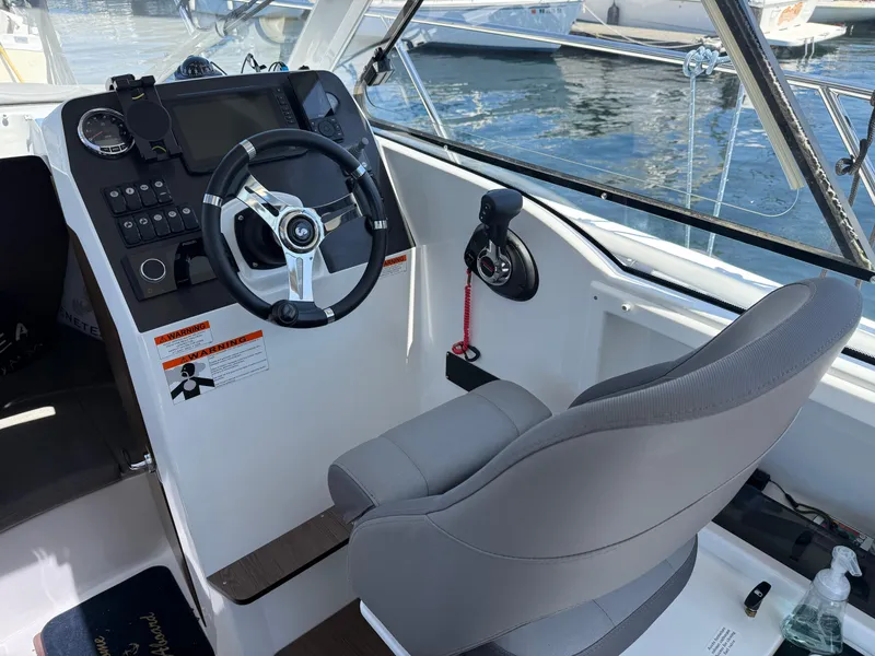 Slide: The Image of Helm of 2021 Beneteau Antares 8 boat with steering wheel and control panel. - 5
