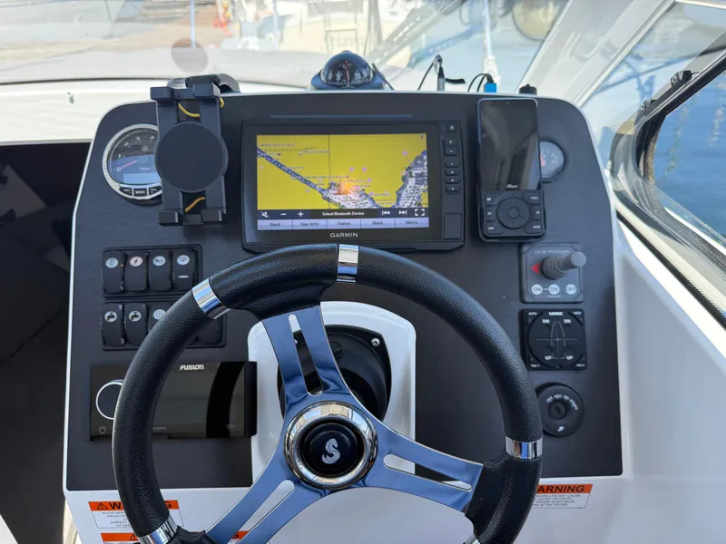 Slide: The Image of Dashboard of 2021 Beneteau Antares 8 with Garmin navigation system and steering wheel. - 6