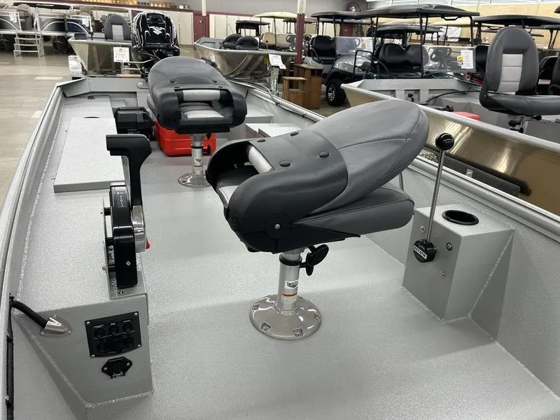 Slide: The Image of 2025 Xtreme River Skiff 1542SS interior with swivel seats and control panel. - 2