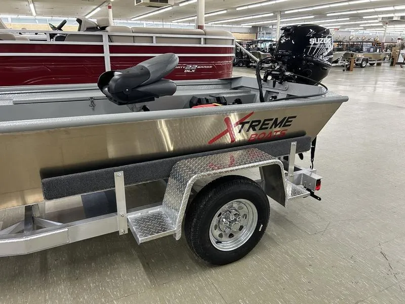 Slide: The Image of 2025 Xtreme River Skiff 1542SS boat on trailer in showroom. - 8