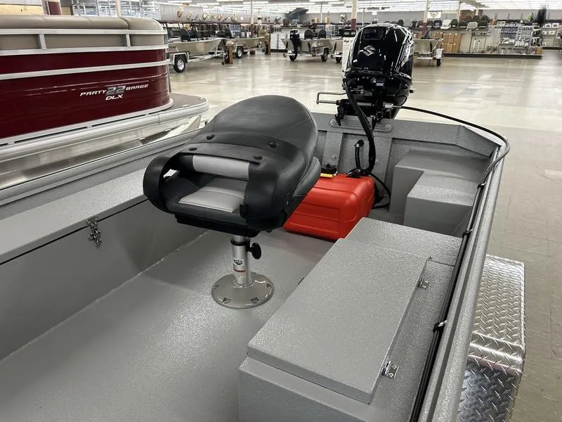 Slide: The Image of 2025 Xtreme River Skiff 1542SS boat interior with seat and motor in showroom. - 9