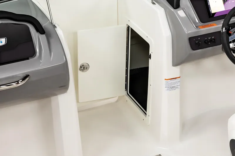 Slide: The Image of 2025 Chaparral OB Ski & Fish boat interior storage compartment with open door. - 15