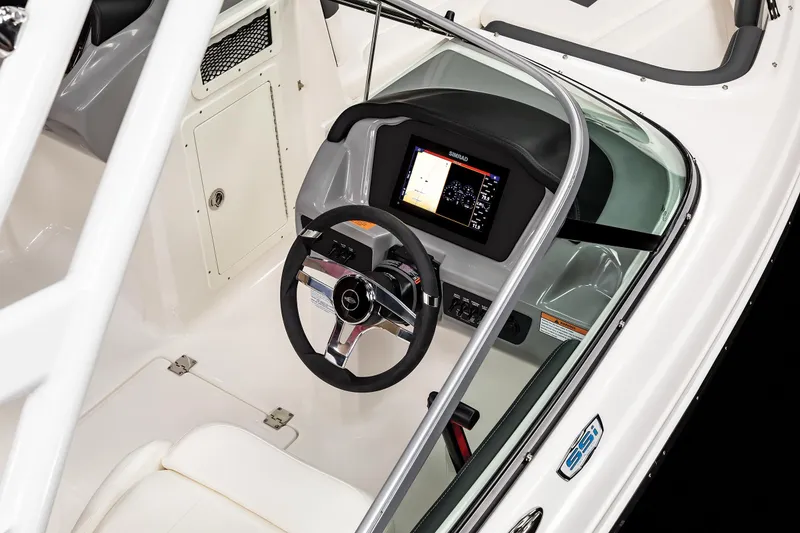 Slide: The Image of 2025 Chaparral OB Ski & Fish boat interior with steering wheel and control panel. - 17