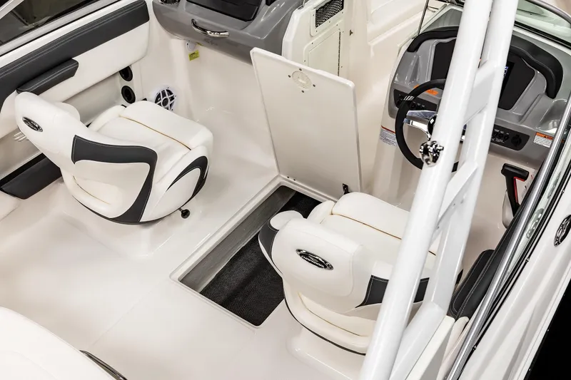 Slide: The Image of 2025 Chaparral OB Ski & Fish boat interior with white seating and modern dashboard. - 19