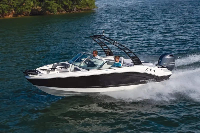 Slide: The Image of 2025 Chaparral OB Ski & Fish boat cruising on a lake with two passengers. - 2