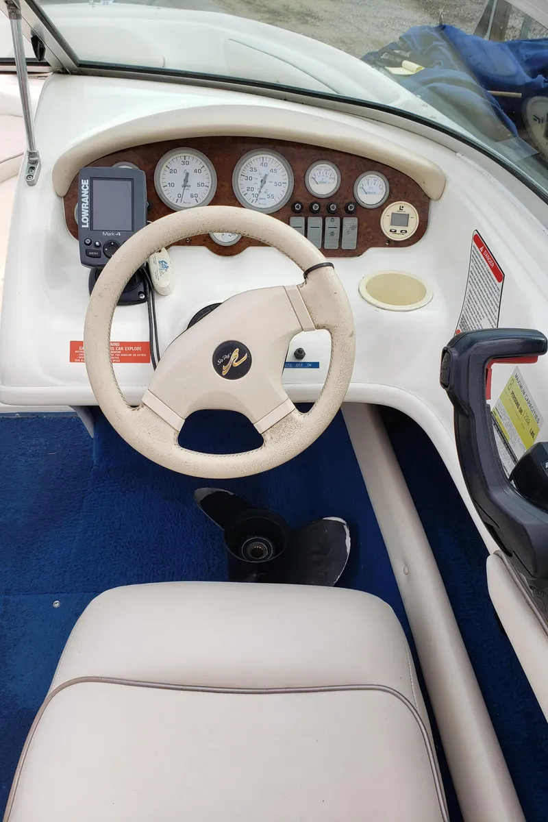 Slide: The Image of 1995 Sea Ray 195BR boat dashboard with steering wheel and instrument panel. - 4