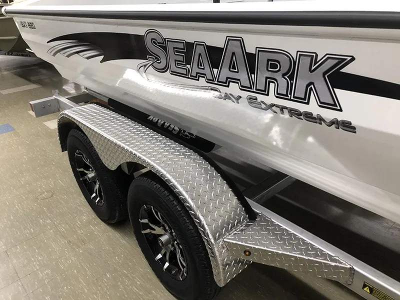 Slide: The Image of 2023 SeaArk BXT220 Bay Tunnel boat on a trailer with diamond plate fenders. - 10