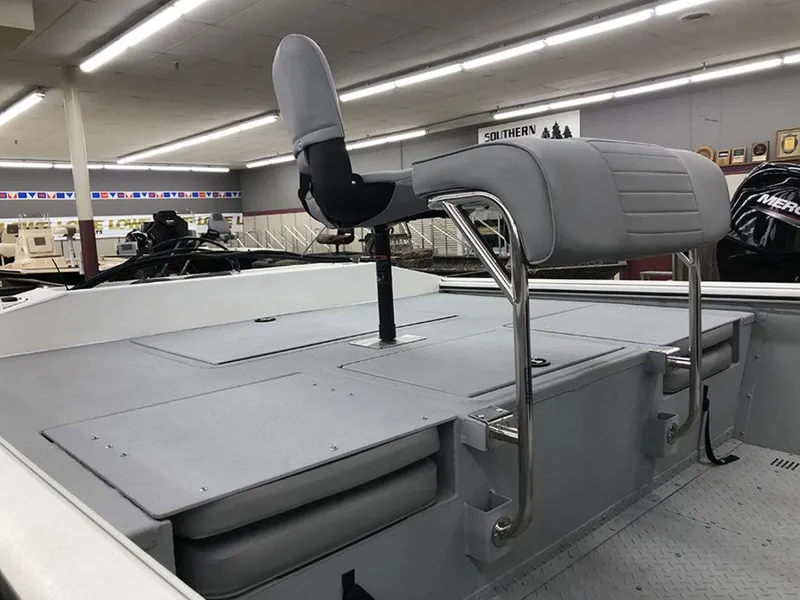 Slide: The Image of 2023 SeaArk BXT220 Bay Tunnel boat interior with gray seating and storage compartments. - 3