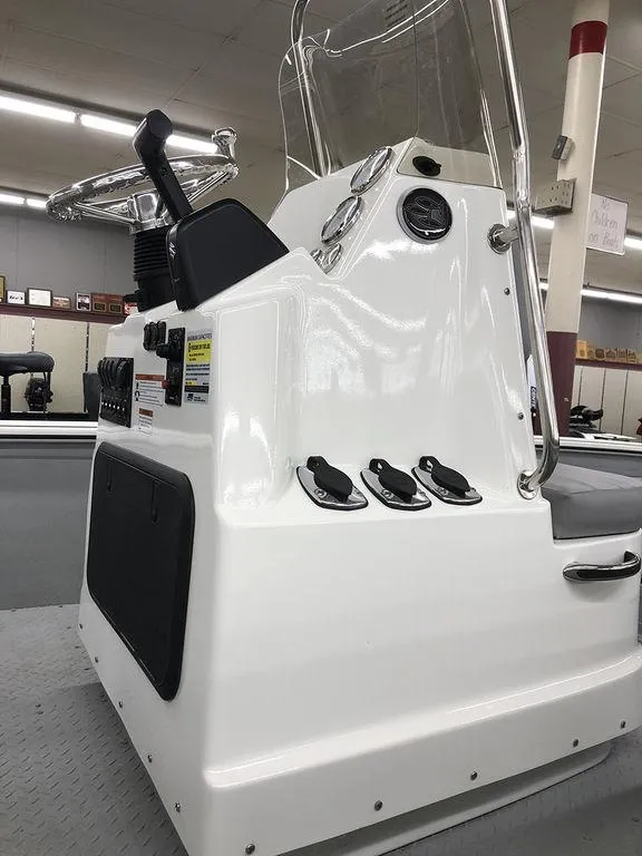 Slide: The Image of 2023 SeaArk BXT220 Bay Tunnel boat console with steering wheel and controls. - 4