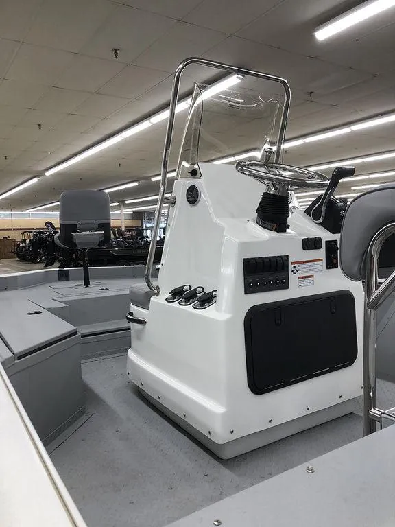 Slide: The Image of 2023 SeaArk BXT220 Bay Tunnel boat interior with control console and seating. - 5