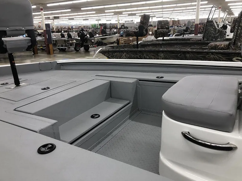 Slide: The Image of 2023 SeaArk BXT220 Bay Tunnel boat interior with seating and storage compartments. - 7