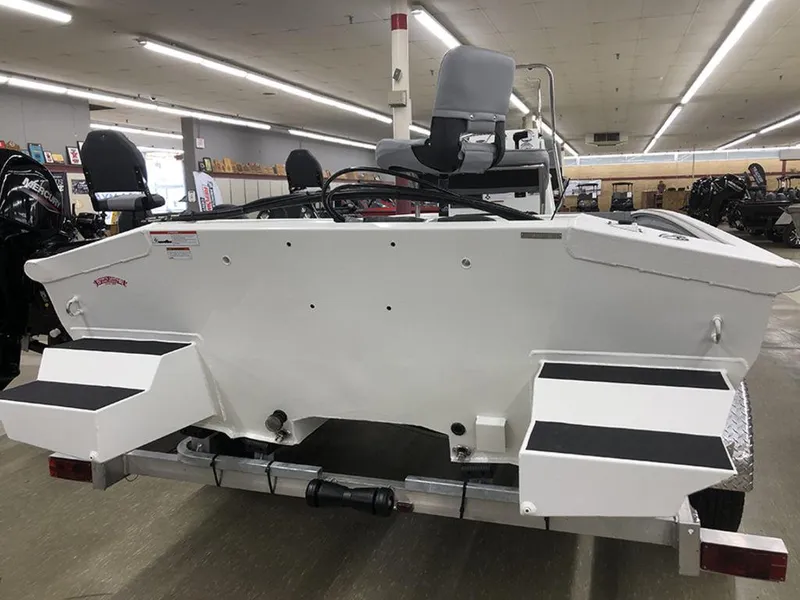 Slide: The Image of 2023 SeaArk BXT220 Bay Tunnel boat displayed indoors, rear view. - 8