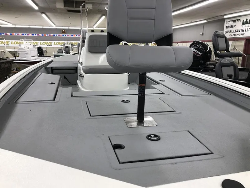 Slide: The Image of 2023 SeaArk BXT220 Bay Tunnel boat interior with gray seating and storage compartments. - 9