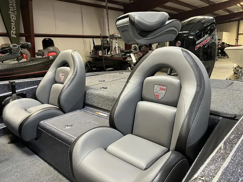 Slide: The Image of 2023 Triton 179 TrX boat interior with gray seating and logo. - 12