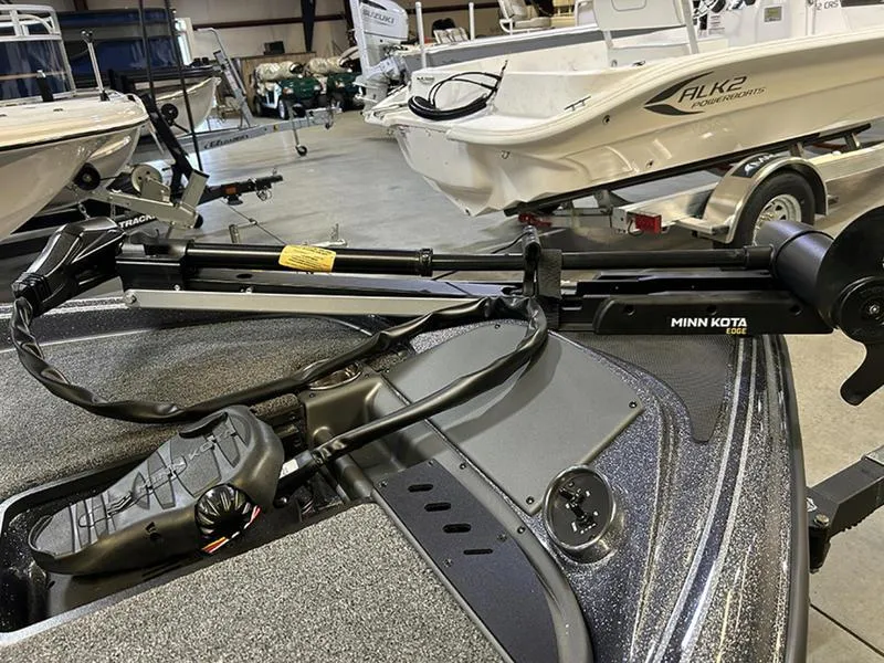 Slide: The Image of 2023 Triton 179 TrX boat with Minn Kota trolling motor in a showroom. - 3