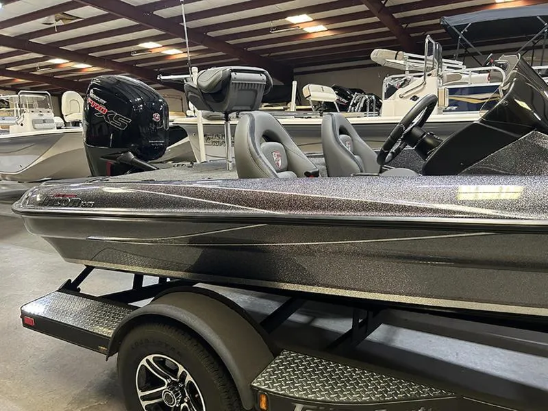 Slide: The Image of 2023 Triton 179 TrX boat in showroom, featuring sleek design and modern seating. - 6