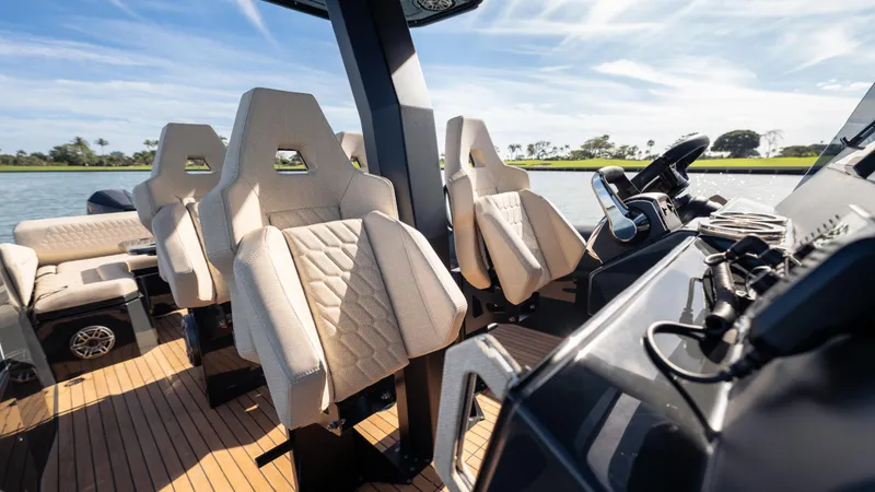 Slide: The Image of 2025 Skipper-BSK 38 boat interior with modern seating and sleek design on a sunny day. - 12