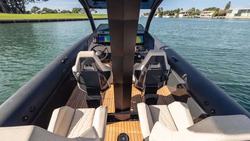 Slide: The Image of Interior view of 2025 Skipper-BSK 38 boat with modern seating and controls on the water. - 16
