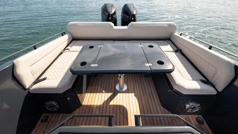 Slide: The Image of Luxurious 2025 Skipper-BSK 38 boat interior with cushioned seating and table on teak deck. - 18