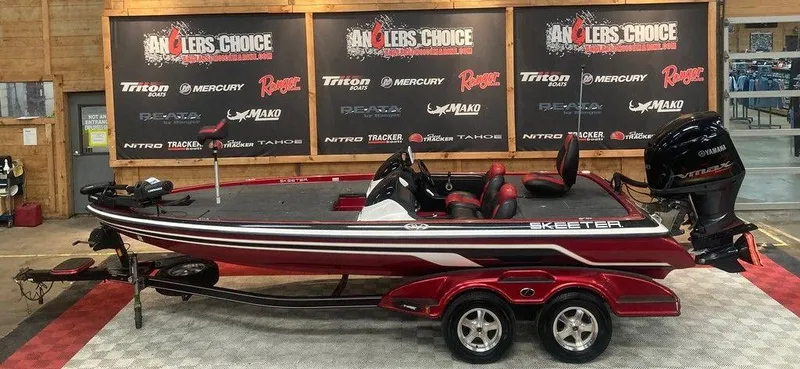 The Image of 2008 Skeeter 20 I bass boat displayed indoors with promotional banners in the background. - 1