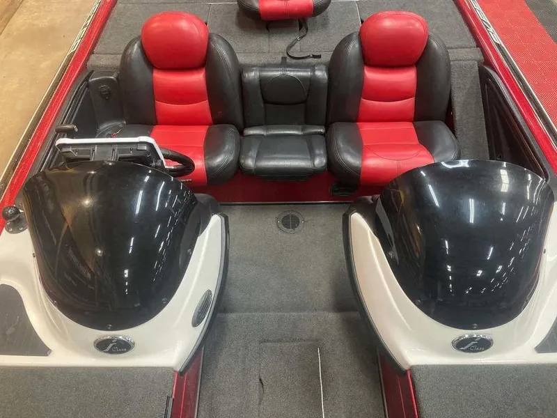 Slide: The Image of 2008 Skeeter 20 I boat interior with red and black seating, dual consoles. - 10