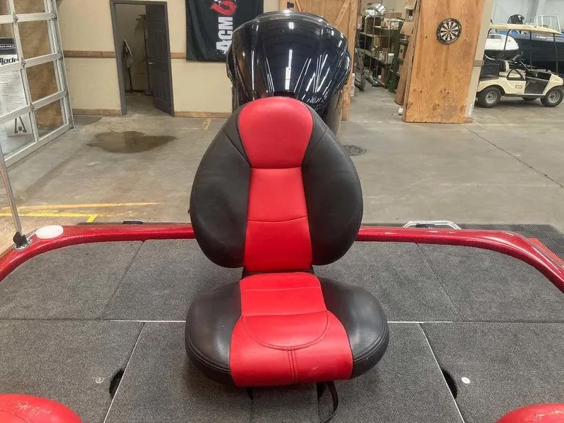 Slide: The Image of Red and black seat on 2008 Skeeter 20 I boat in a garage setting. - 11