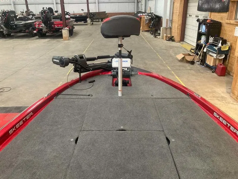 Slide: The Image of 2008 Skeeter 20 I boat interior with trolling motor in a garage setting. - 8