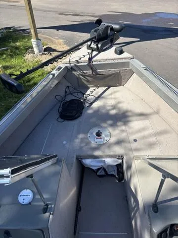 Slide: The Image of 2001 Lund 1700 Fisherman boat interior with trolling motor and storage compartments. - 11