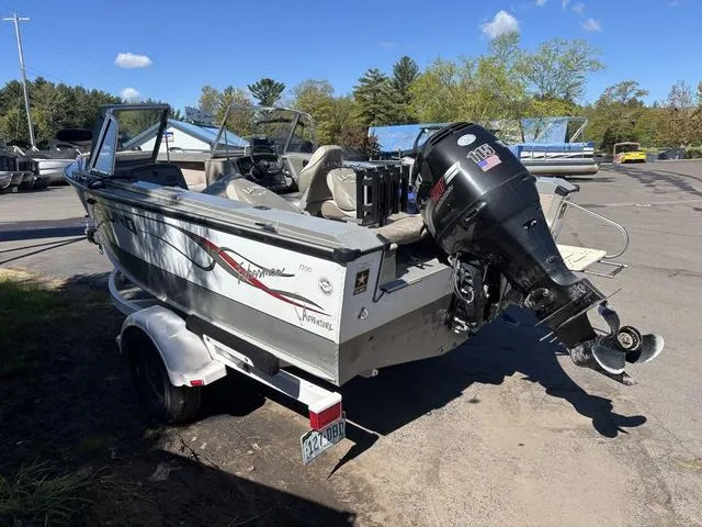 Slide: The Image of 2001 Lund 1700 Fisherman boat with outboard motor on a trailer, parked outdoors. - 5