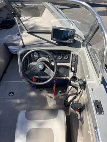 Slide: The Image of 2001 Lund 1700 Fisherman boat interior with steering wheel and navigation equipment. - 8