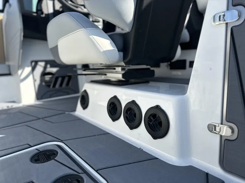 Slide: The Image of Interior of 2025 Malibu 25 LSV boat with modern seating and speaker system. - 10