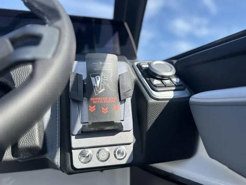 Slide: The Image of 2025 Malibu 25 LSV boat dashboard with throttle and control panel. - 12