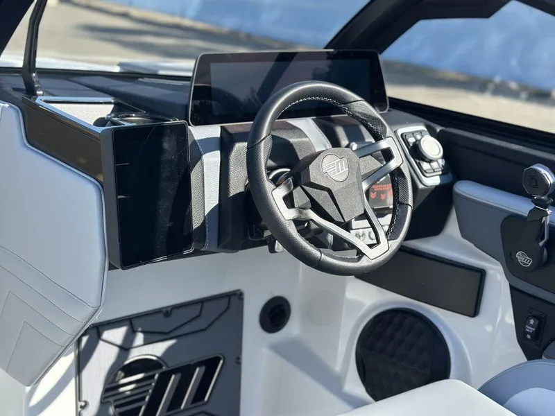 Slide: The Image of 2025 Malibu 25 LSV boat cockpit with modern steering and dashboard design. - 15