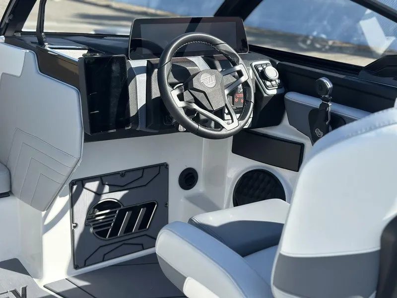 Slide: The Image of 2025 Malibu 25 LSV boat interior with modern steering and dashboard design. - 16