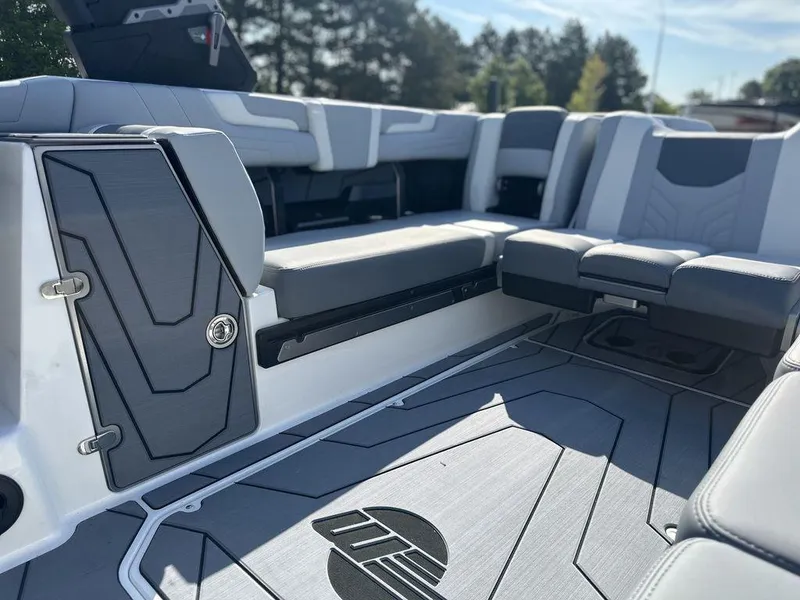 Slide: The Image of 2025 Malibu 25 LSV boat interior with sleek gray seating and modern design. - 17
