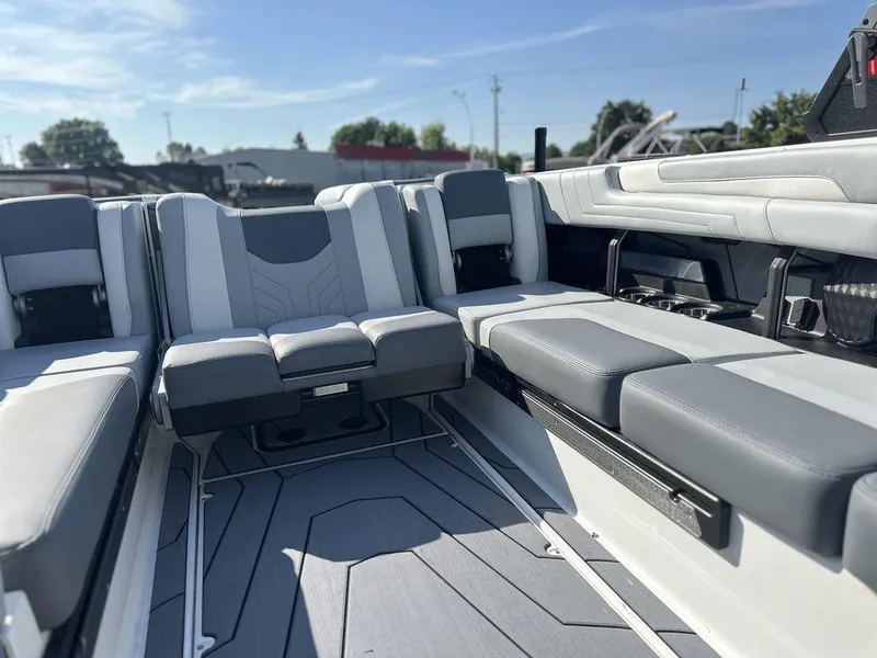 Slide: The Image of 2025 Malibu 25 LSV boat interior with sleek gray seating and modern design. - 18