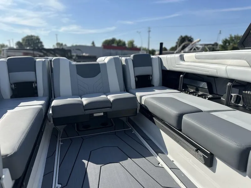 Slide: The Image of 2025 Malibu 25 LSV boat interior with sleek gray and white seating. - 19