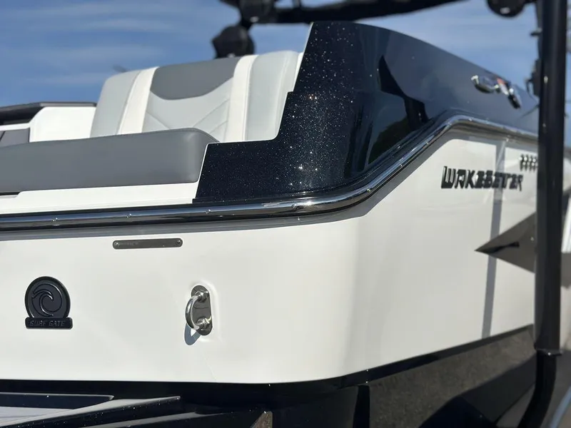 Slide: The Image of 2025 Malibu 25 LSV boat, sleek design, white and black exterior, luxury seating. - 2