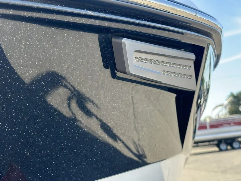 Slide: The Image of Close-up of 2025 Malibu 25 LSV boat's sleek exterior detail. - 21