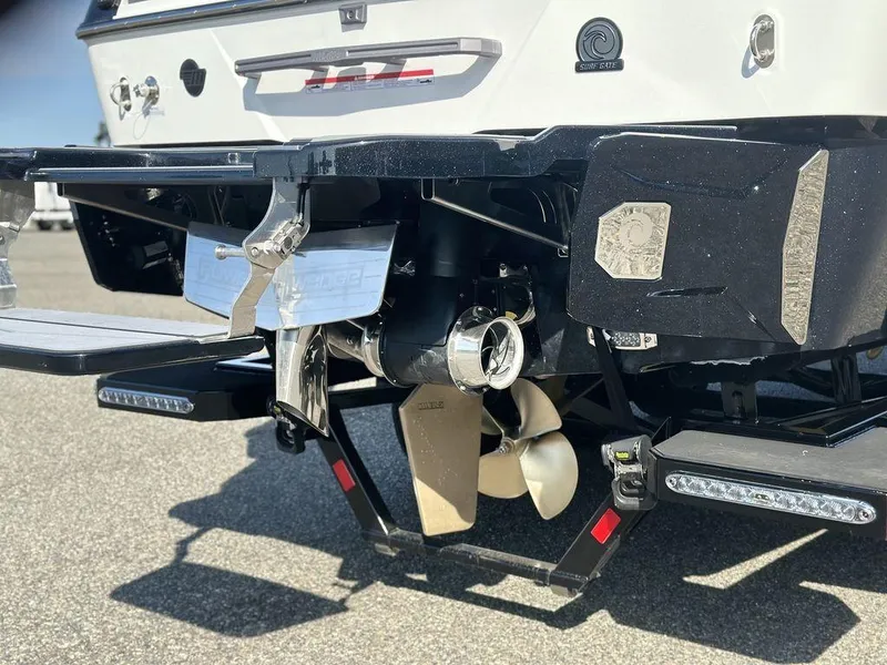 Slide: The Image of 2025 Malibu 25 LSV boat propeller and stern details in sunlight. - 27