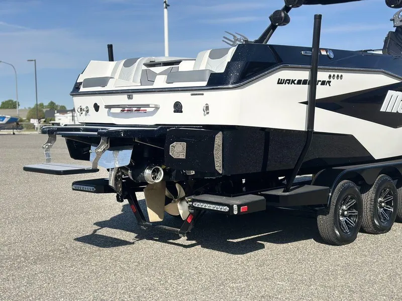 Slide: The Image of 2025 Malibu 25 LSV boat rear view, showcasing sleek design and dual propellers. - 29