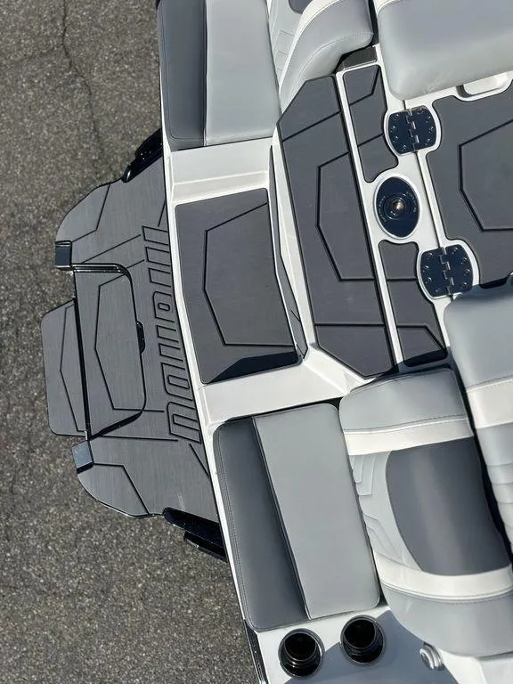 Slide: The Image of 2025 Malibu 25 LSV boat interior with sleek gray and black seating design. - 6