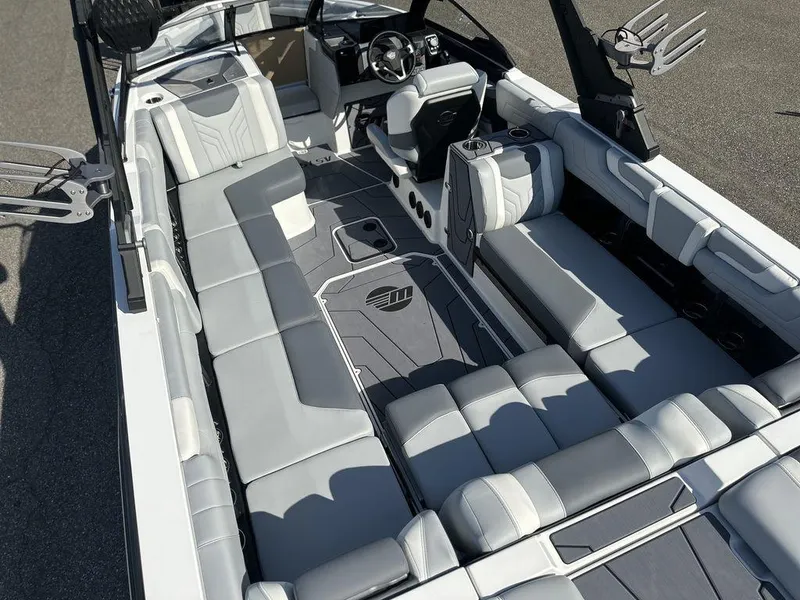 Slide: The Image of 2025 Malibu 25 LSV boat interior with sleek gray seating and modern design. - 7
