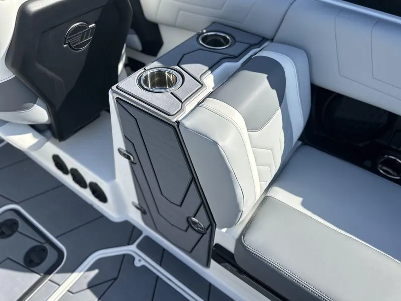 Slide: The Image of 2025 Malibu 25 LSV boat interior with sleek seating and cup holders. - 8