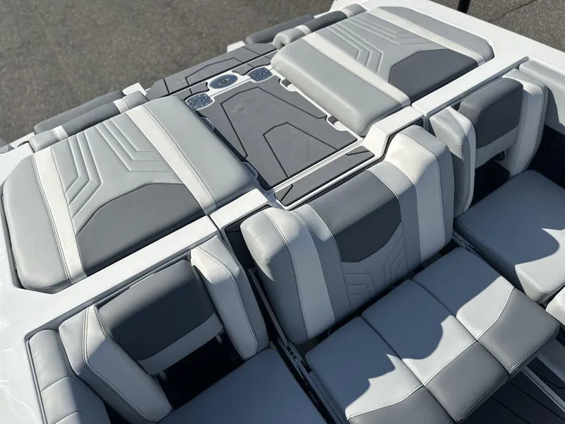Slide: The Image of 2025 Malibu 25 LSV boat interior with sleek gray and white seating design. - 9